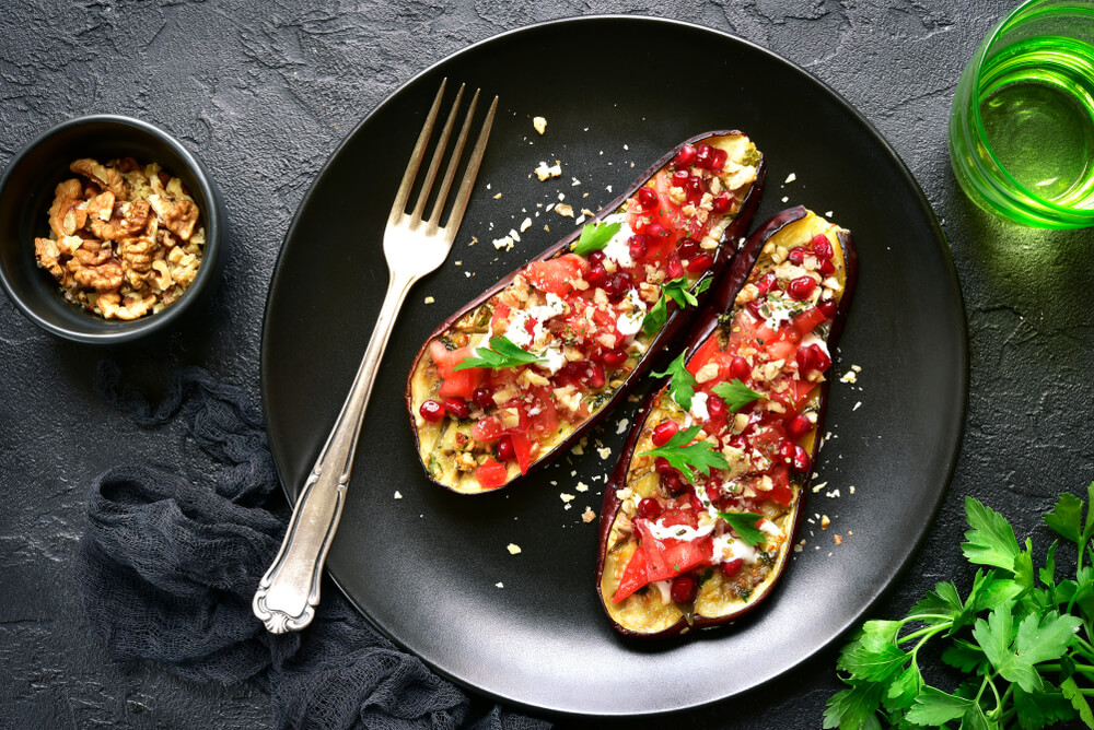 vegetarian stuffed eggplant recipe on black plate